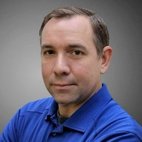 A man in a blue polo with a logo of a "S" stands against a red background. Text reads "Stratford Tennis" and "Head Boys Coach Richard White".