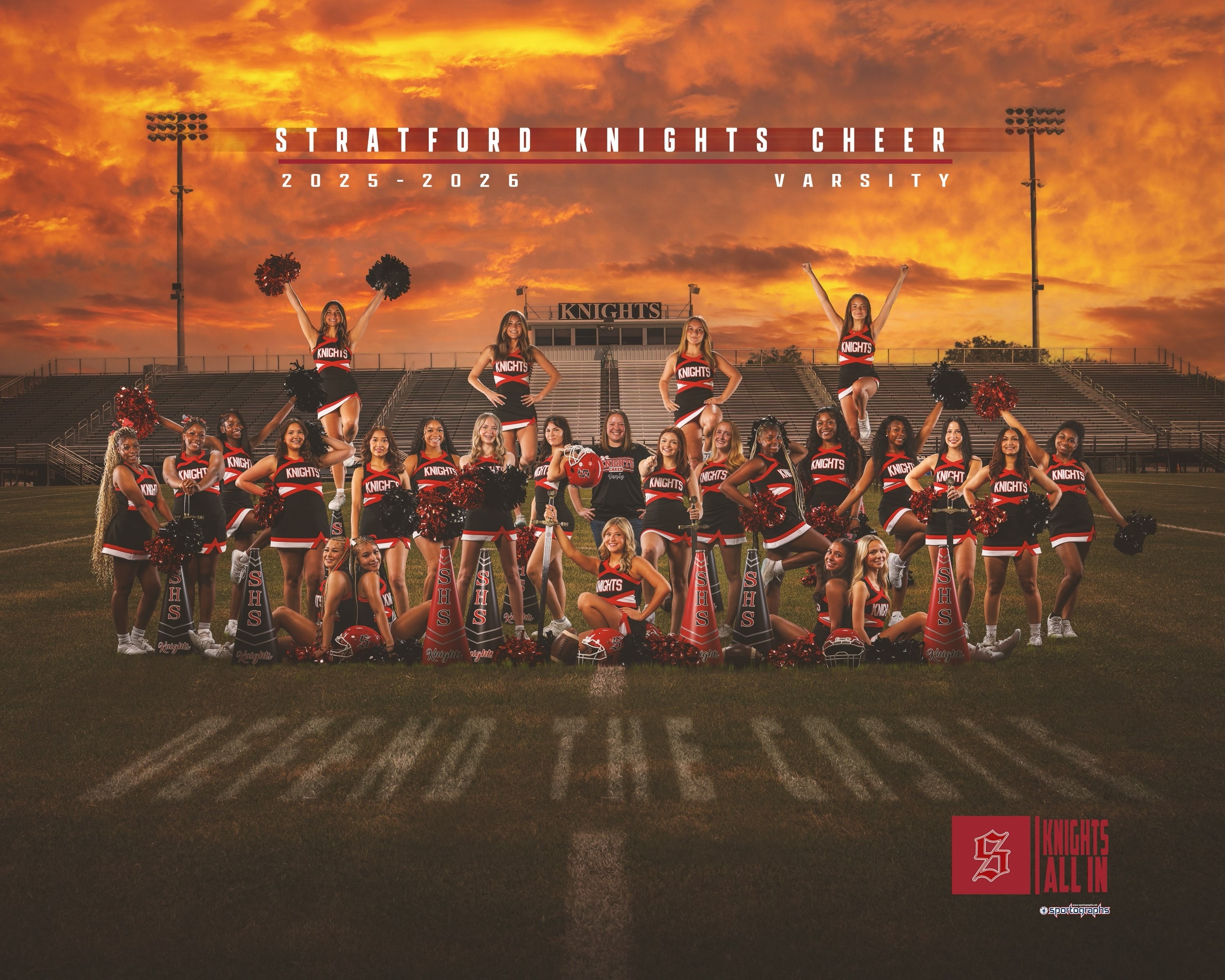 Group photo of a cheerleading team with black and red uniforms, some on top of others, on a football field.