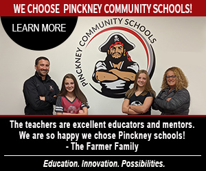 A photo of a family together standing right next to the school's mascot