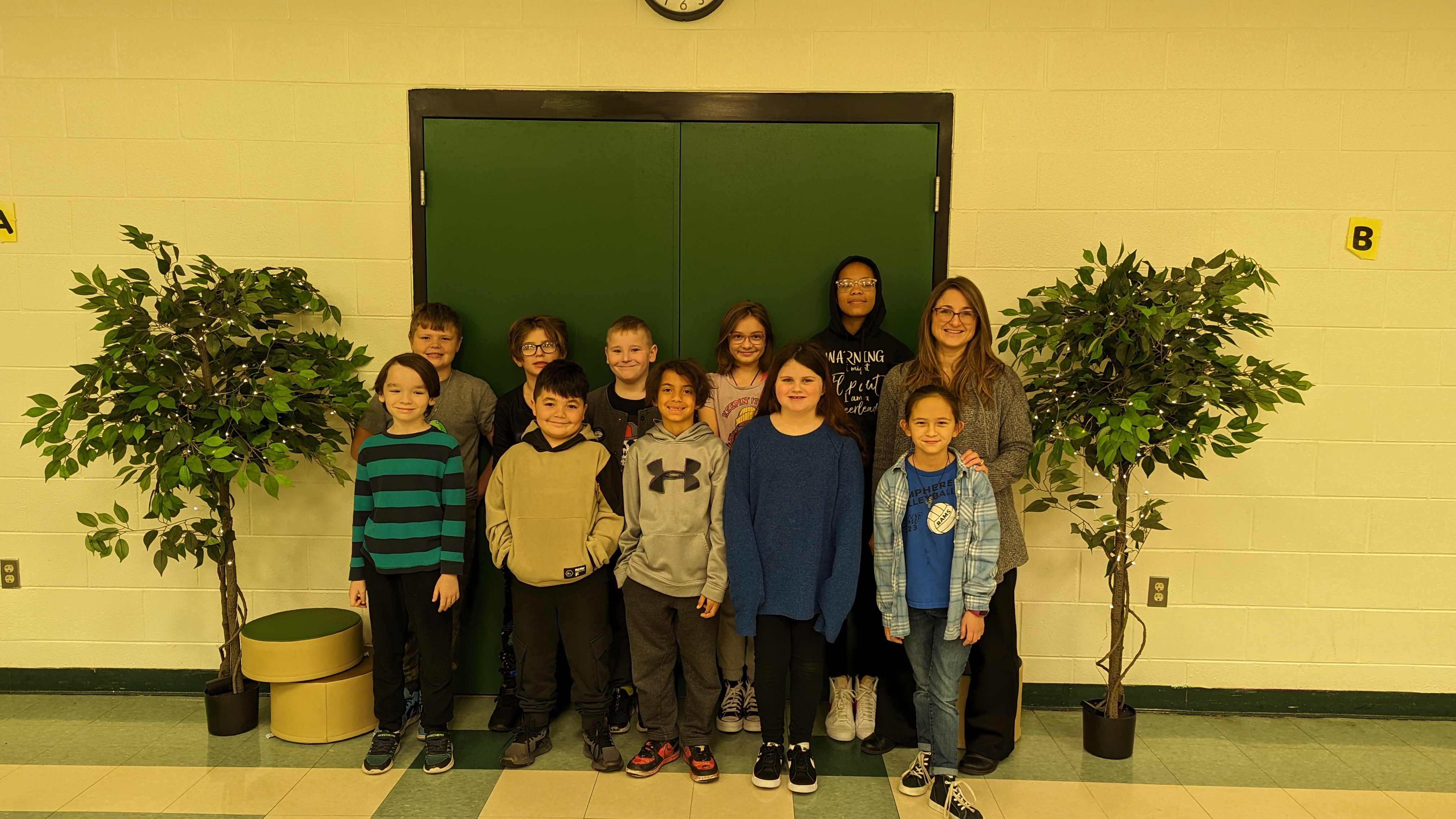 The Cafeteria Crew students and their principal stand in the newly decorated Simonds Cafeteria.