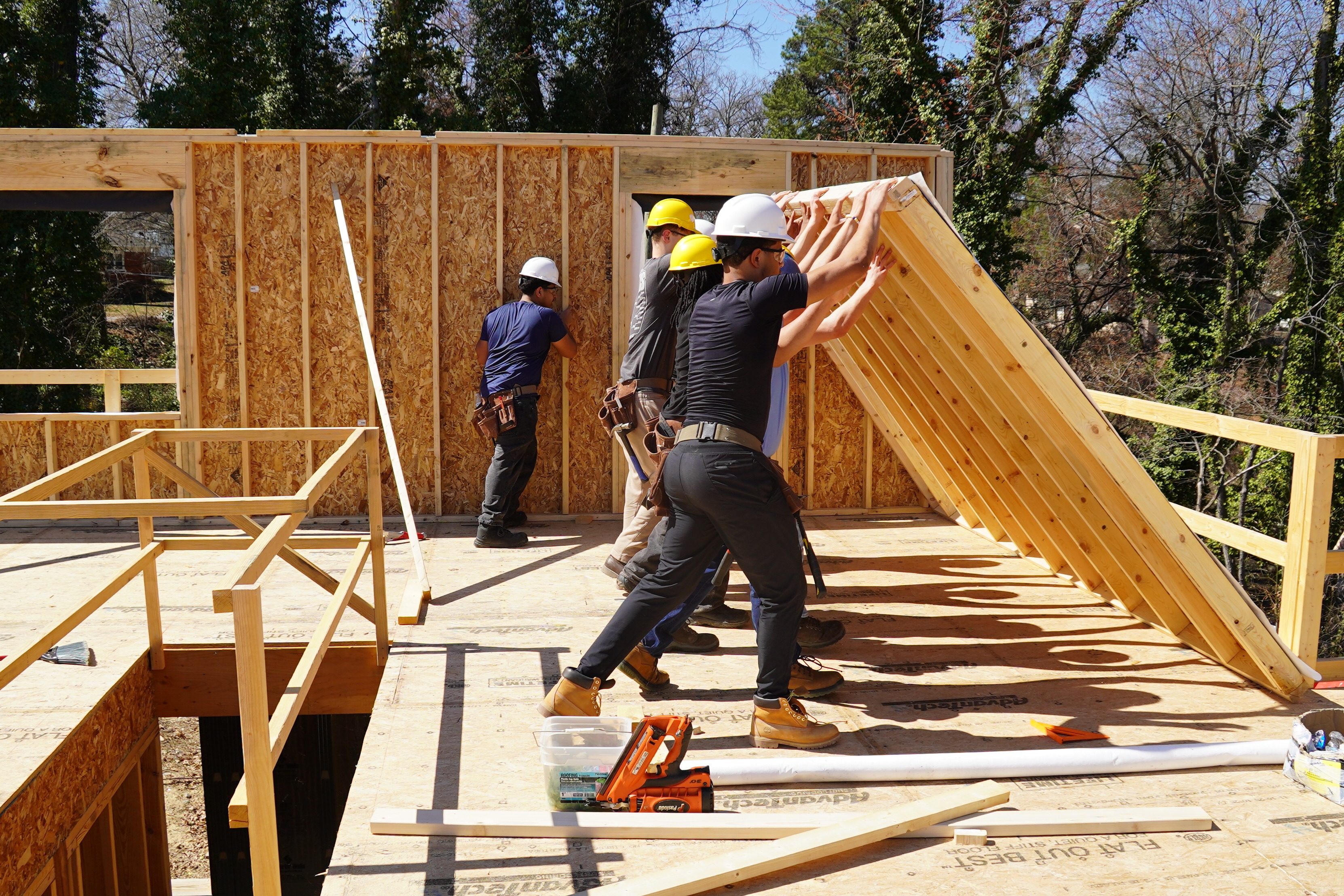 Carpentry students raising a wall.