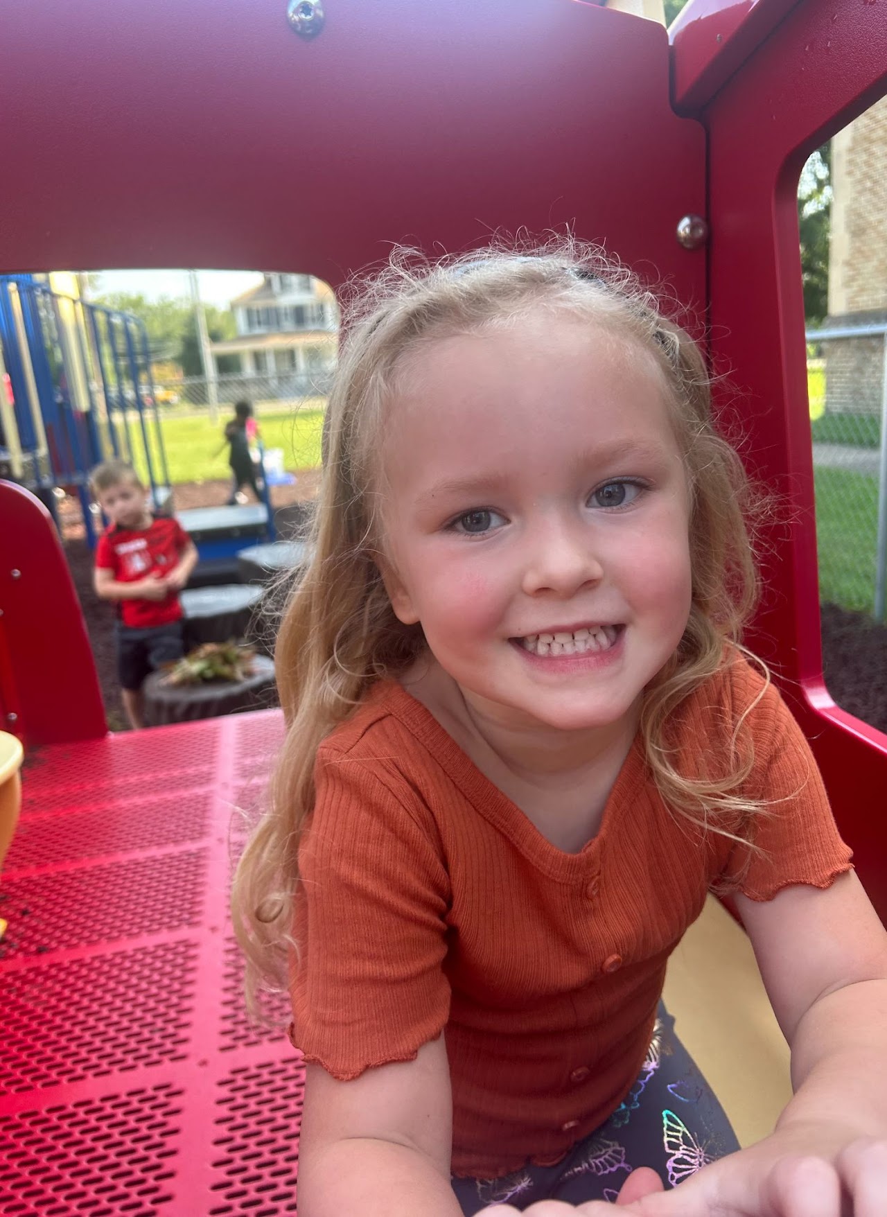 A young girl inside of a park attraction