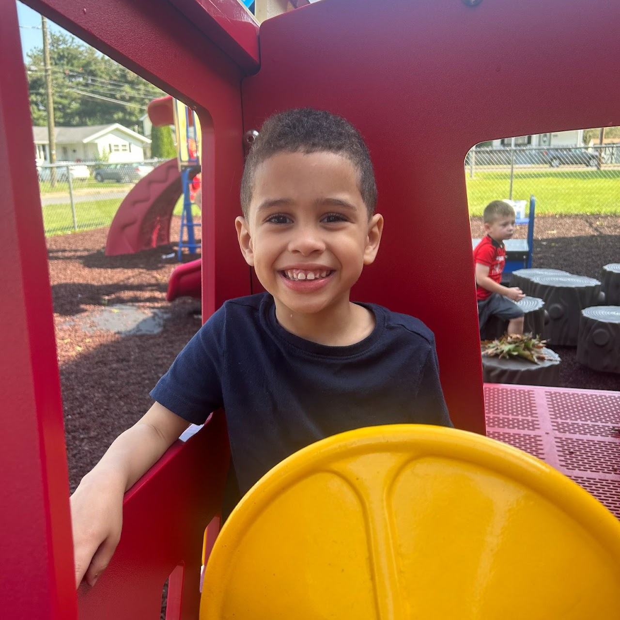 A young boy inside of a park attraction