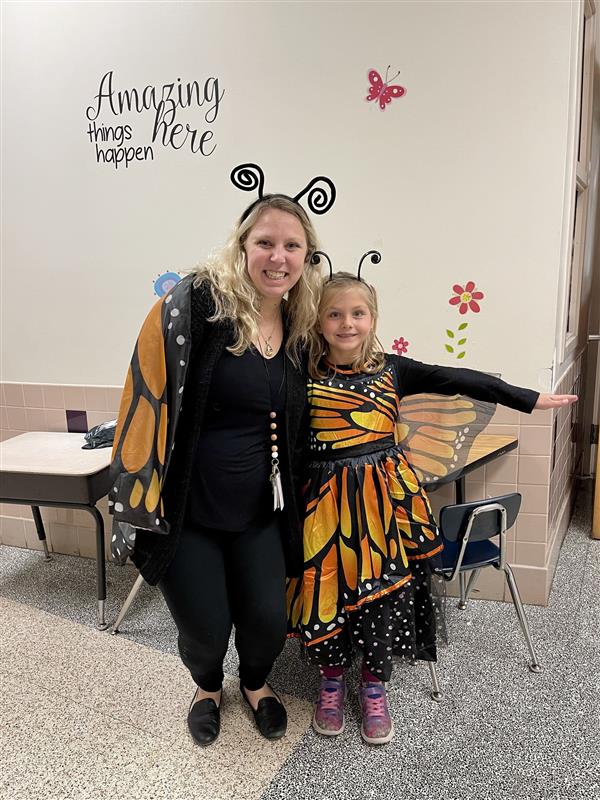 a student and teacher are wearing matching butterfly Halloween costumes