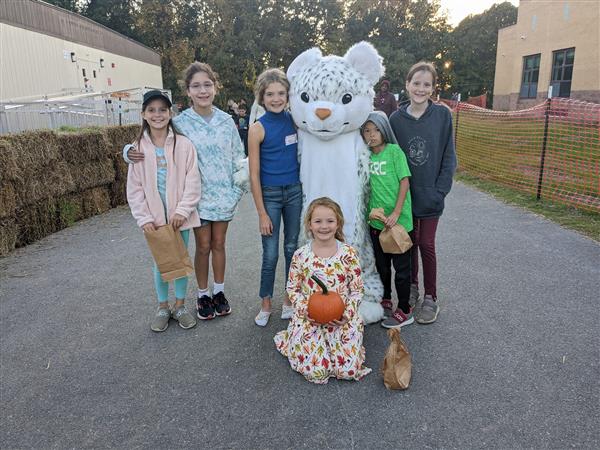 six students are grouped around a Pine Orchard Panther mascot