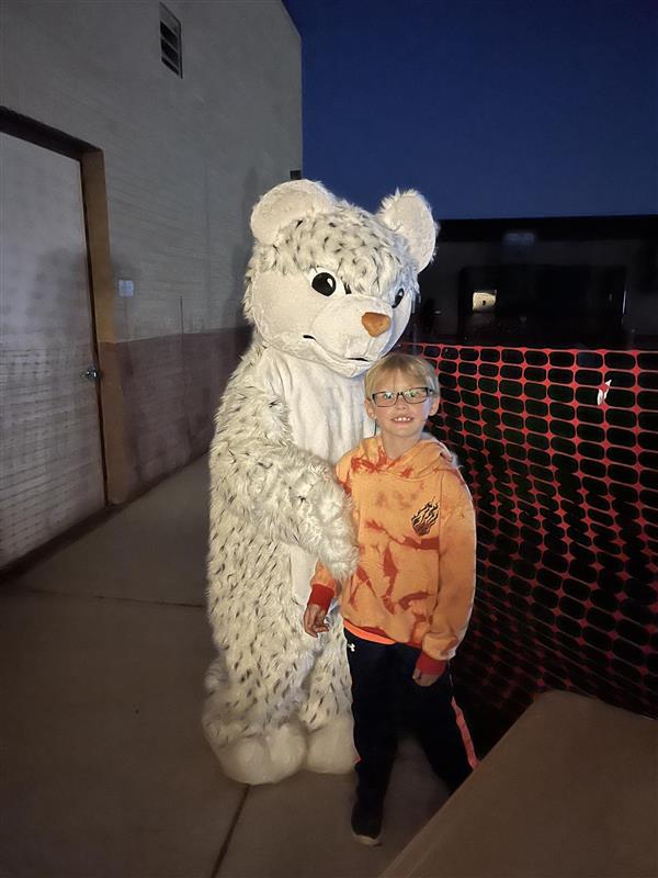 a student hugs a Piney Orchard Panther mascot