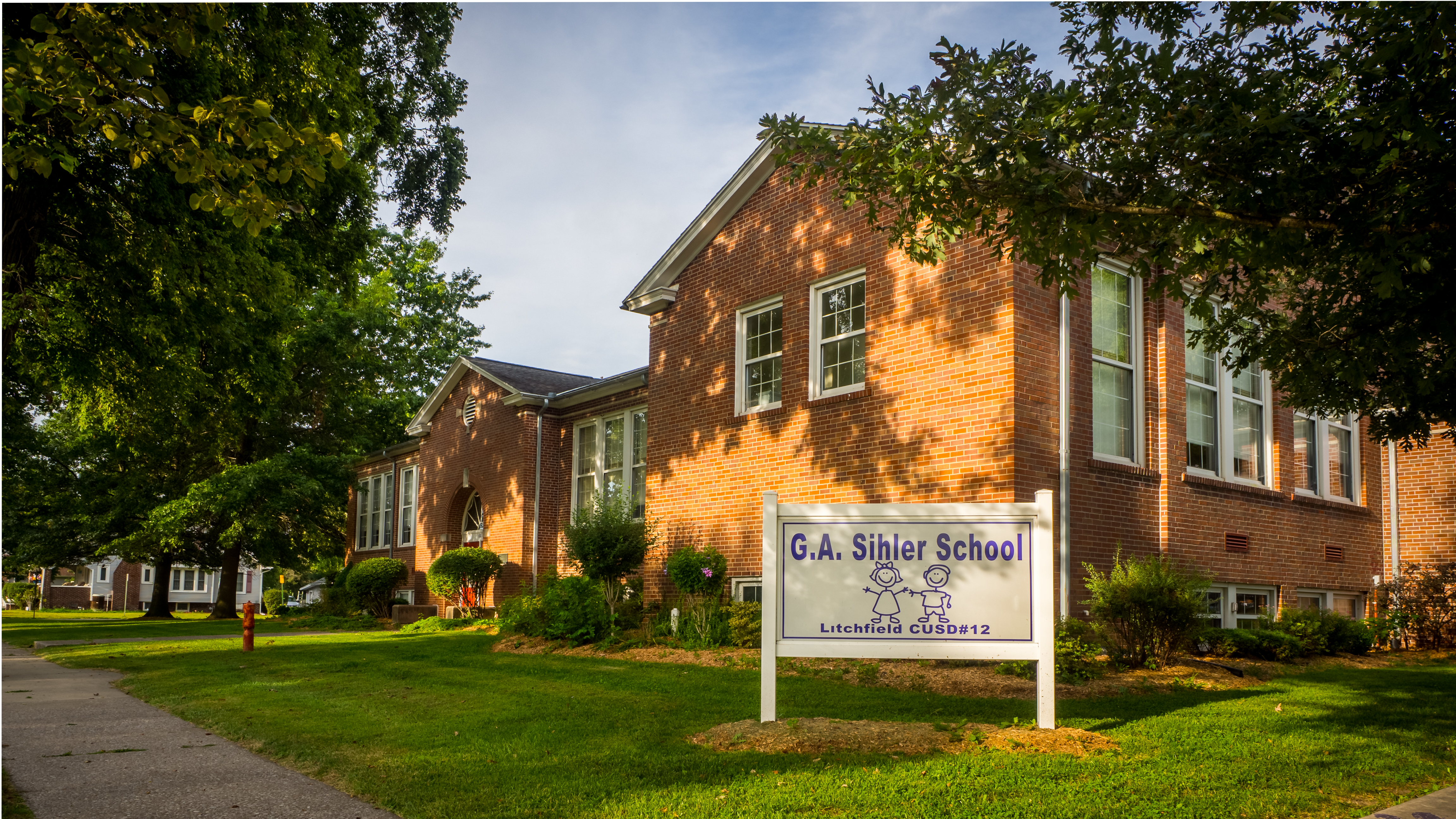 Exterior sunny morning image of Sihler School building