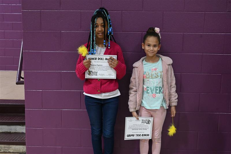 two students holding their diploma of ready award