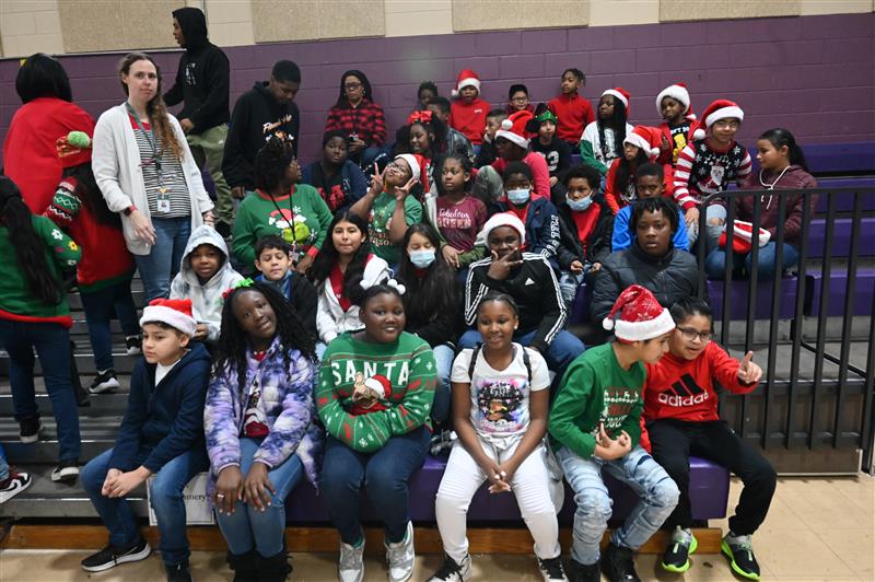 group of students posing for a picture with christmas hats
