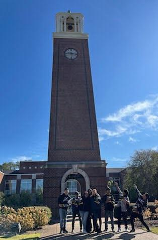 students smiling in front of a tower 