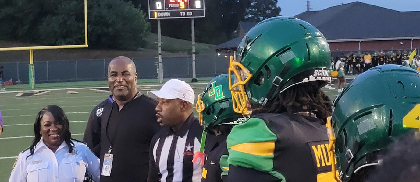 Dr. John Lyons, Jr with the Mustang Football Team
