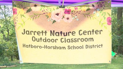 A tent with a sign displayed "Jarrett Nature Center Outdoor Classroom Hatboro-Horsham School District".