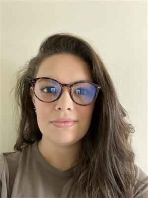 A woman with glasses and a brown shirt.