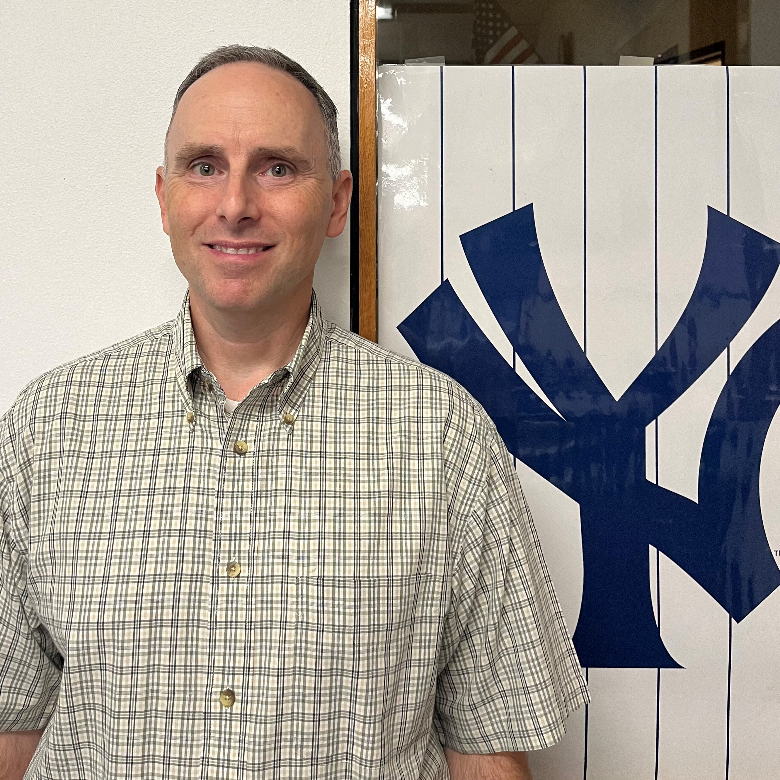 A man wearing a blue shirt and blue polo shirt.
