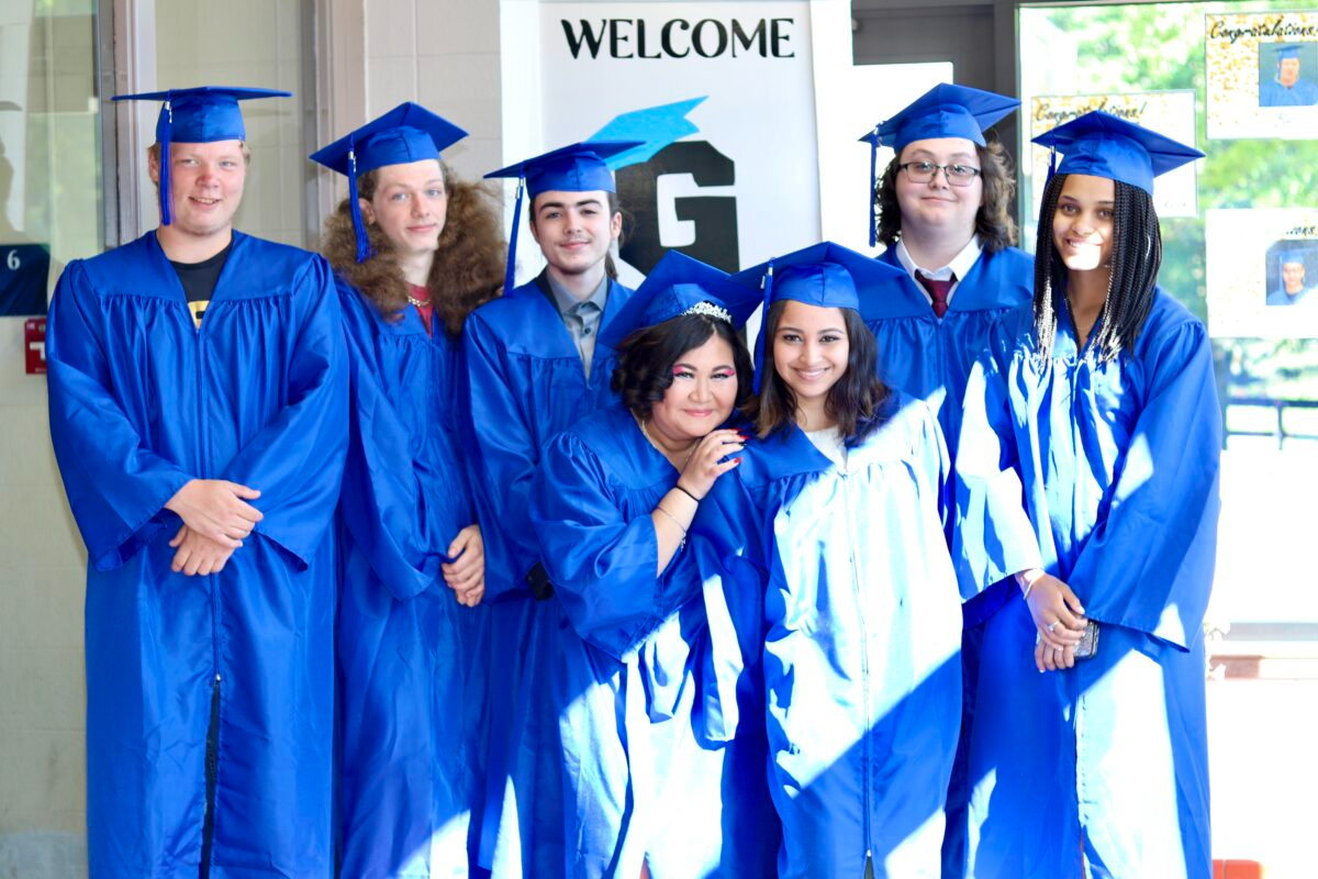 students in blue graduation gowns