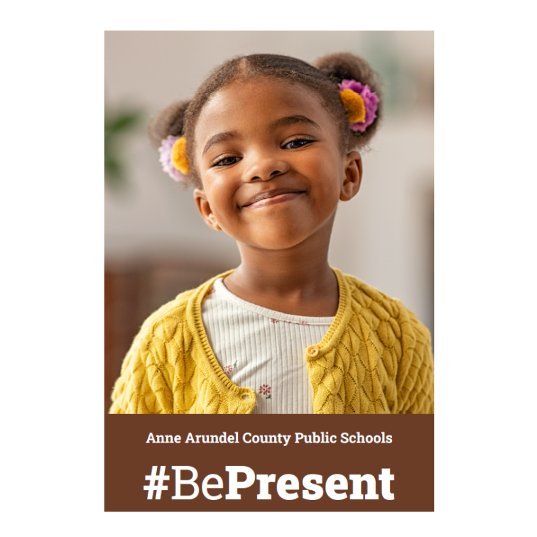 Young student smiling in yellow vest with banner that reads Anne Arundel County Public Schools #BePresent