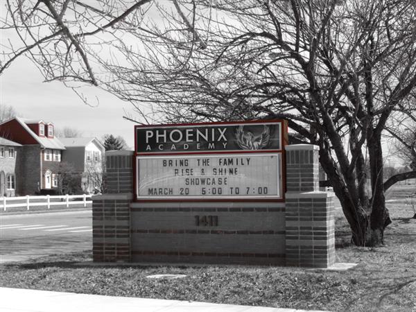 Phoenix Academy external marquee, bearing the message "Bring the family, rise & shine showcase, March 20, 5:00 to 7:00"