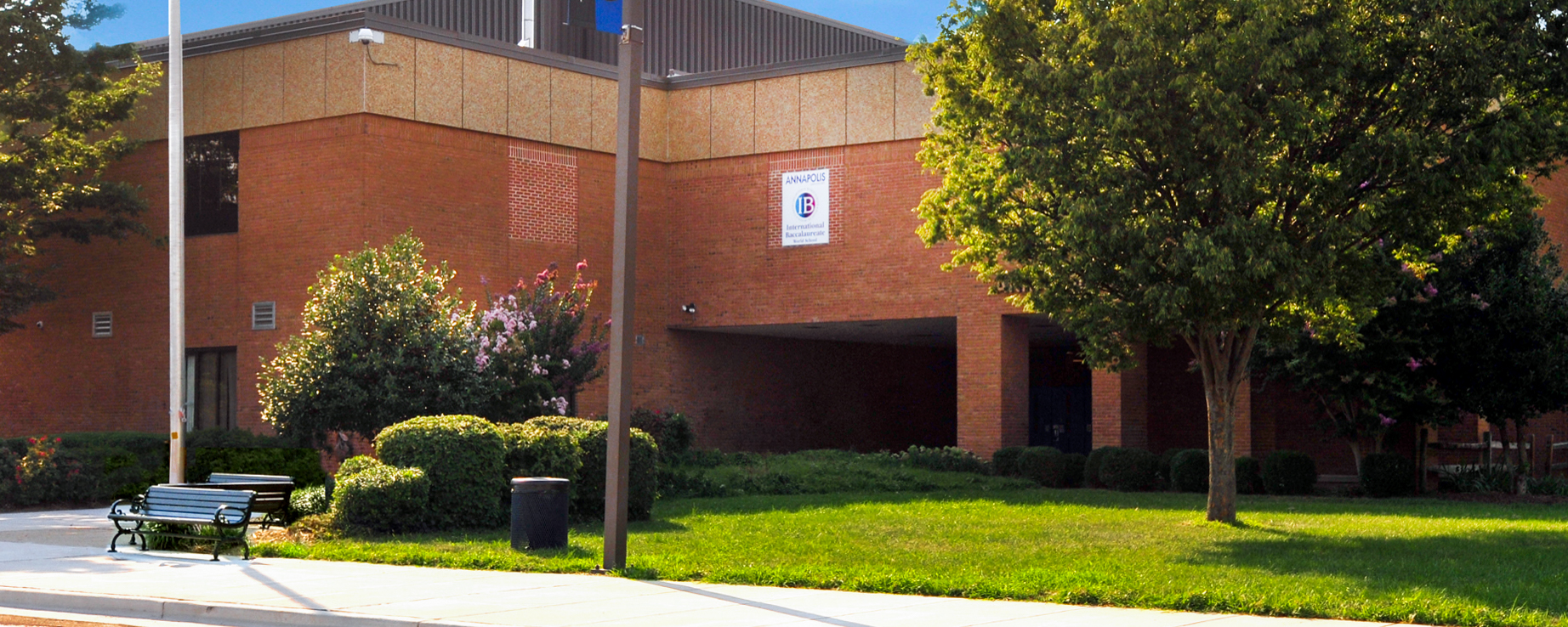 A photo of the front of a school building with a tree