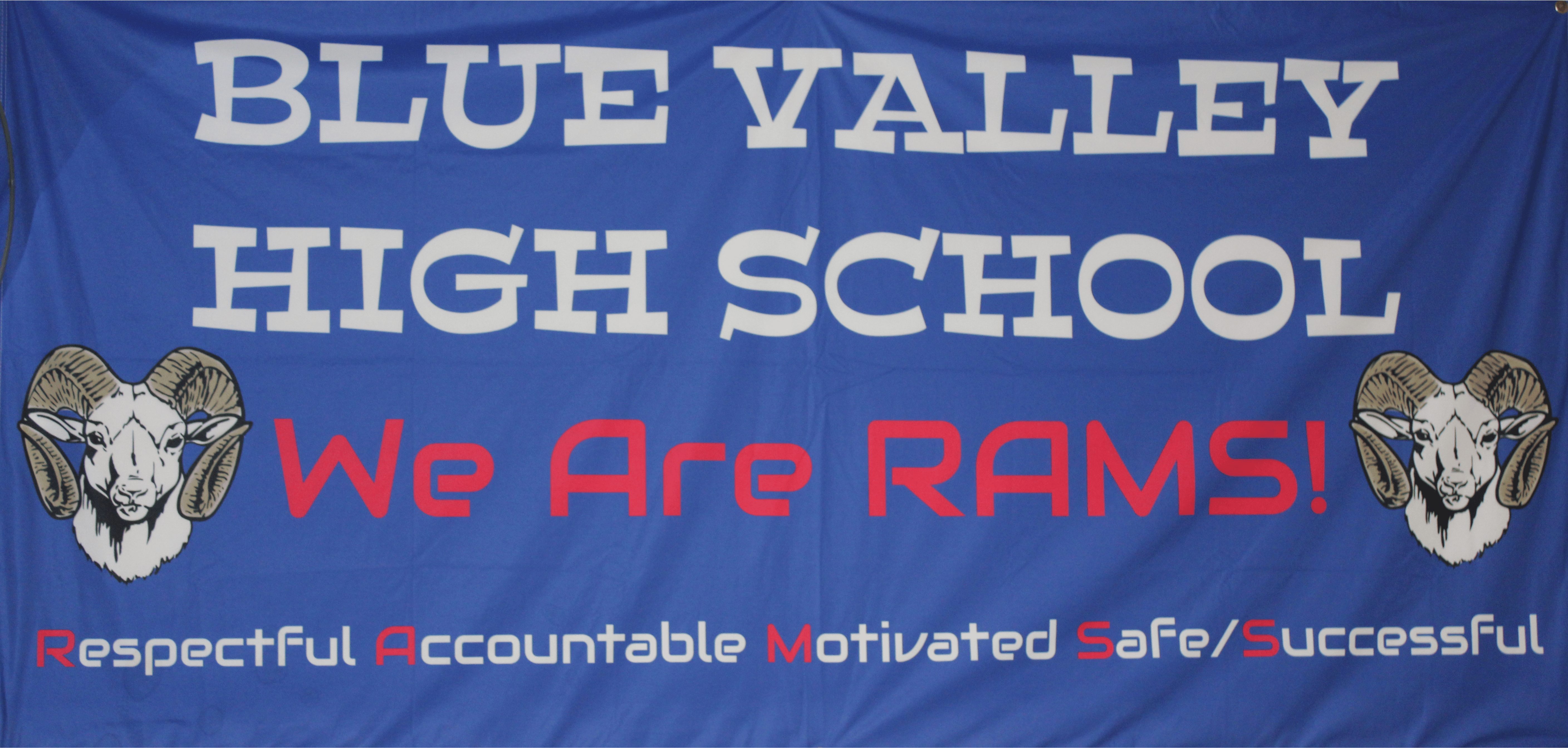 a blue sign saying we are blue valley high school we are rams