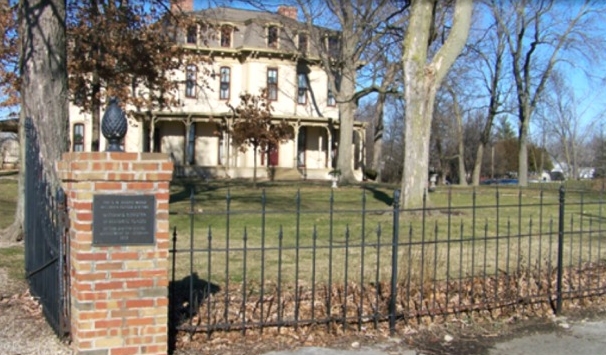 A historical two-story house with a weathered facade