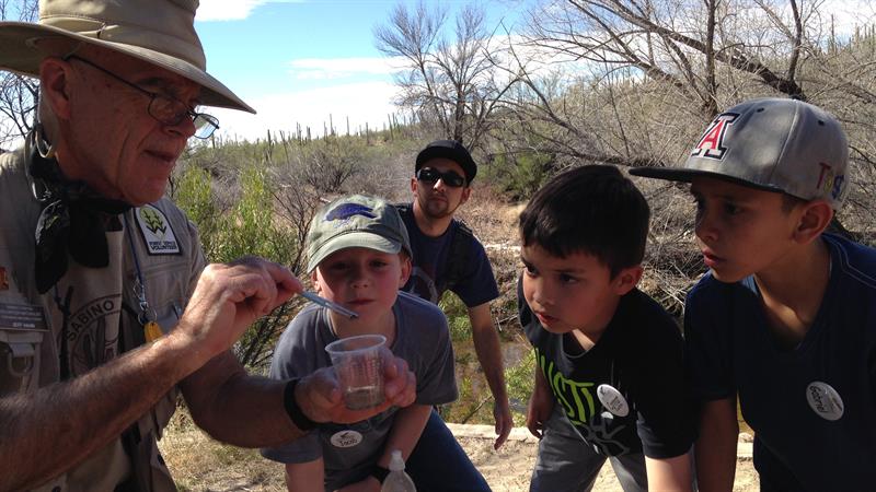 leader and kids exploring on a hiking