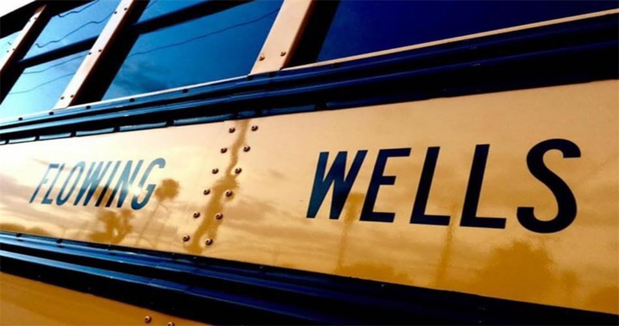 close up of a school bus that says flowing wells