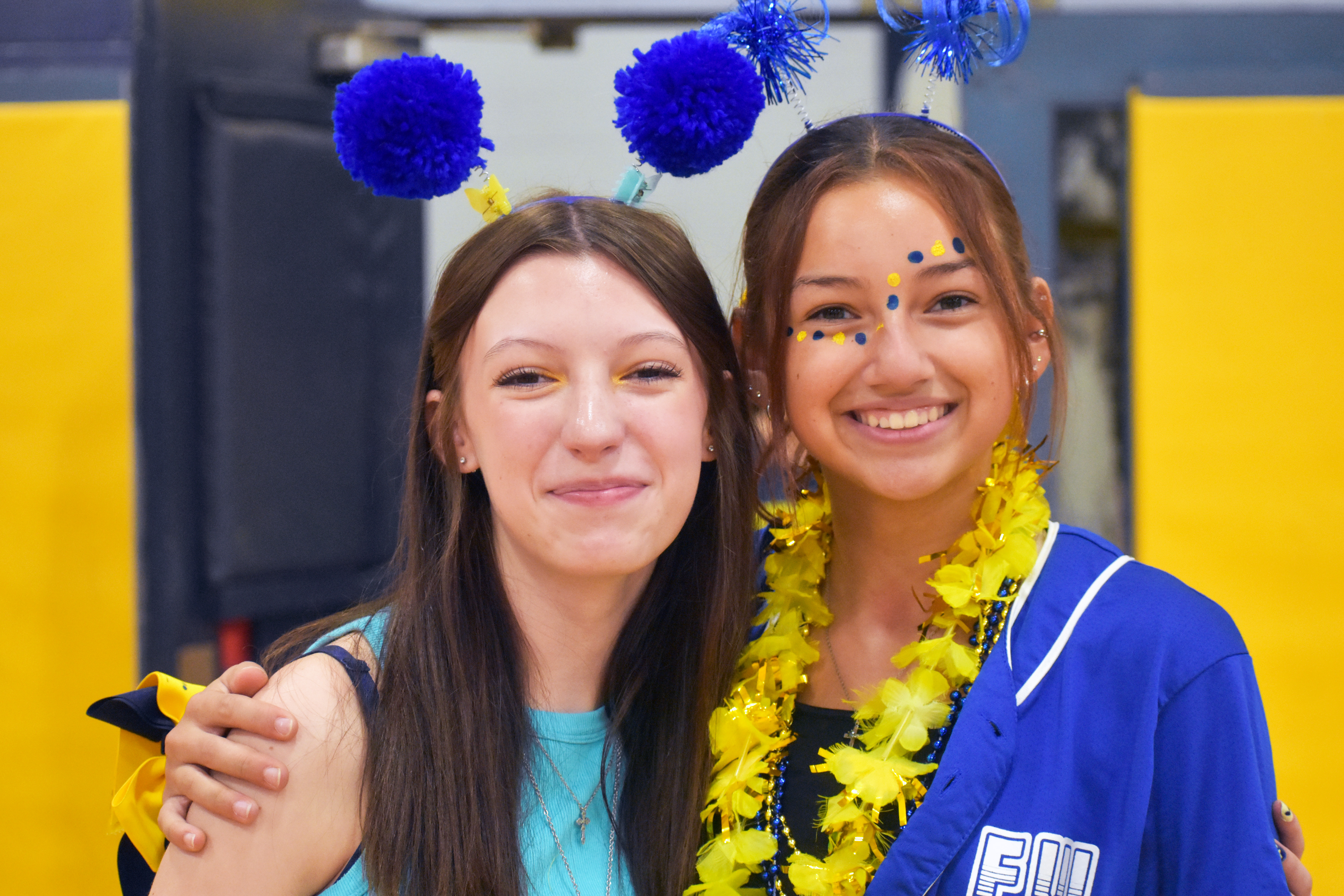 two junior high students at a pep assembly