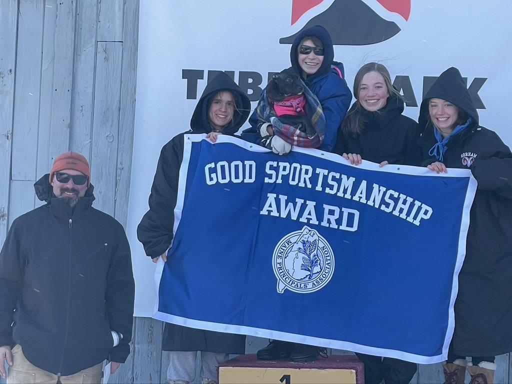 Group of diverse individuals holding trophies and smiling, winners of the good sportsmanship award.