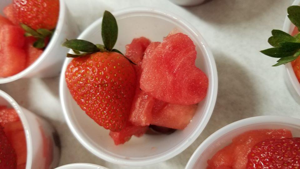 Strawberries and watermelon in small cups on a table