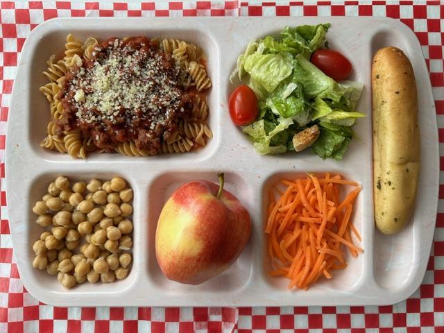 A plastic tray with a variety of food on it