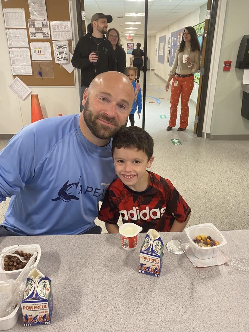 A man and a young boy sitting at a table