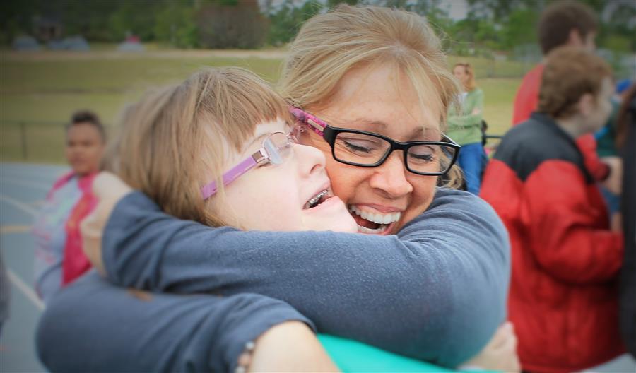 Two persons hugging