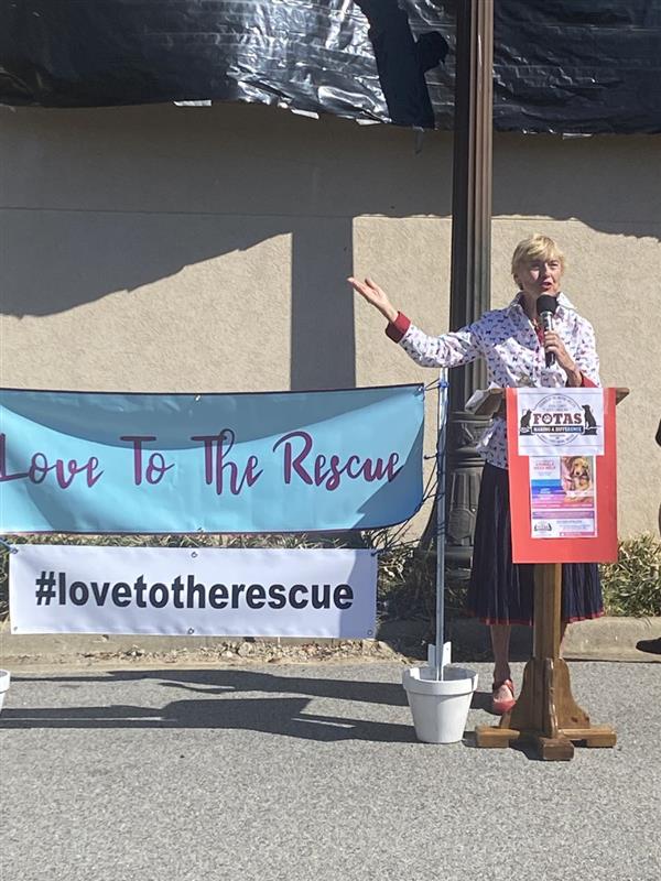 Teacher showing The Love to the Rescue Wall
