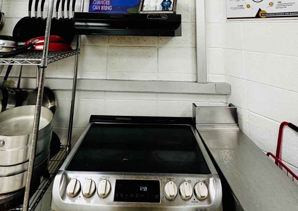 An oven with open shelving above it. 