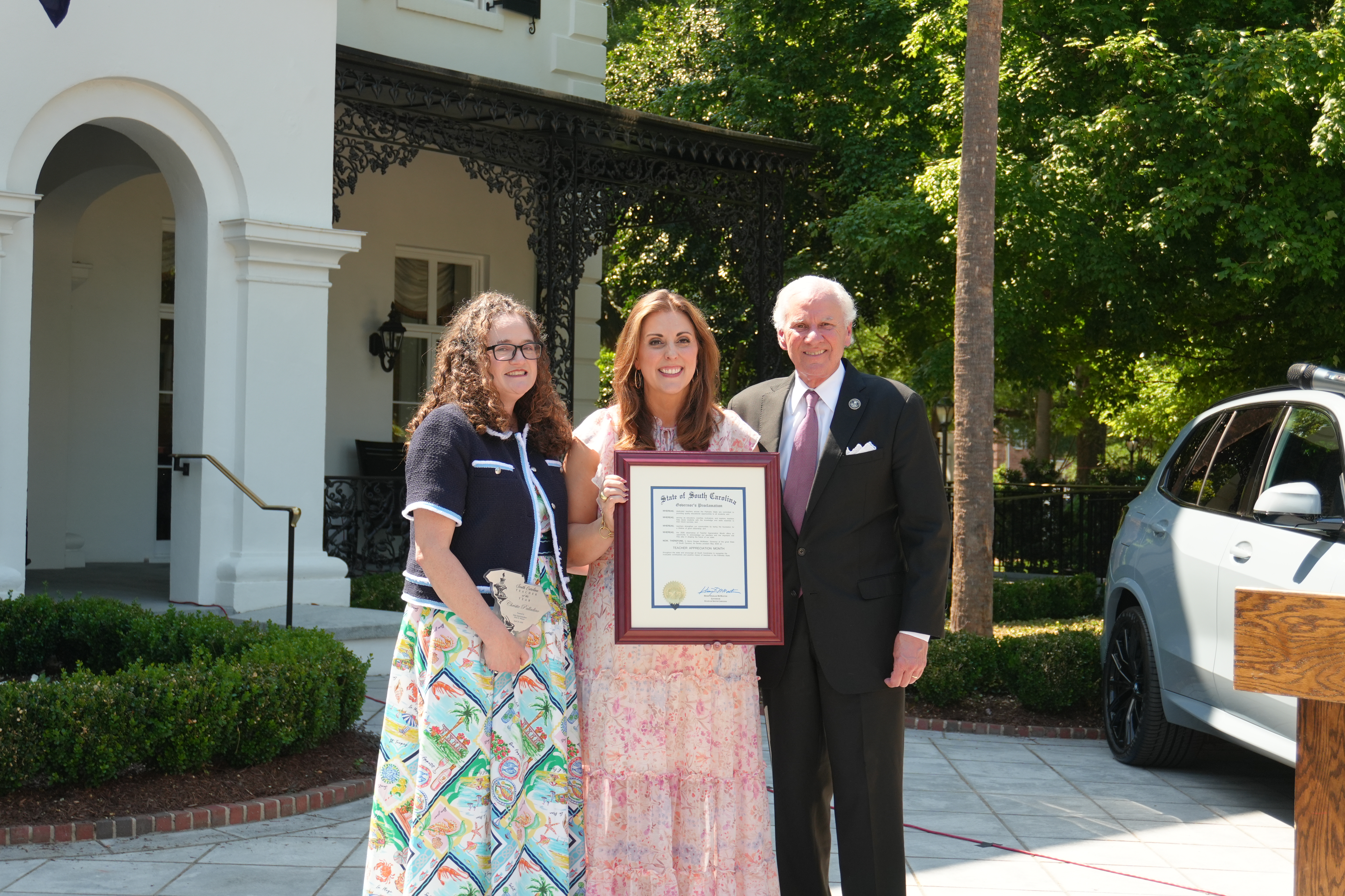 South Carolina Superintendent of Education and Governor holding award of SC Teacher of the Year with Dr. Palladino.