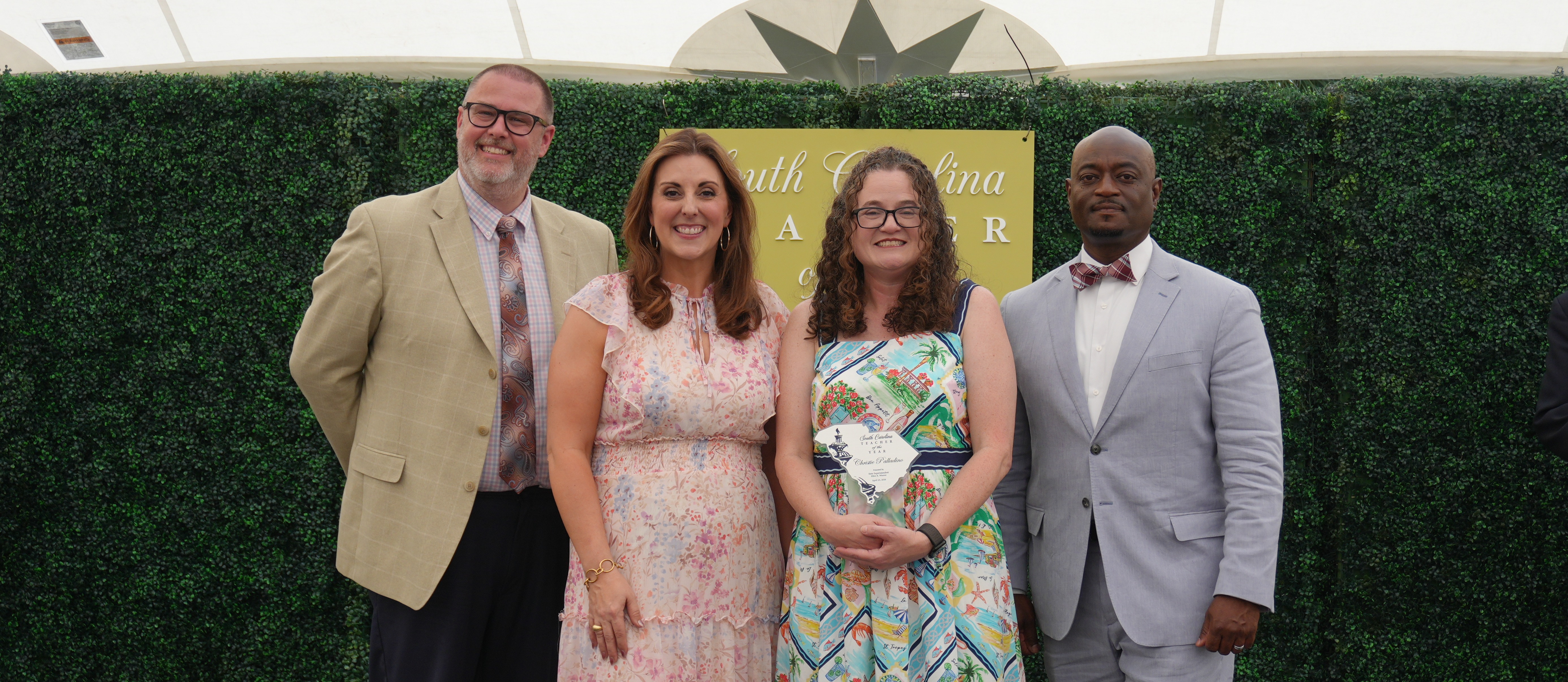 South Carolina Superintendent of Education and Superintendent of ACPSD along with Principal Harris smiling next to Dr. Palladino after winning State Teacher of the Year.
