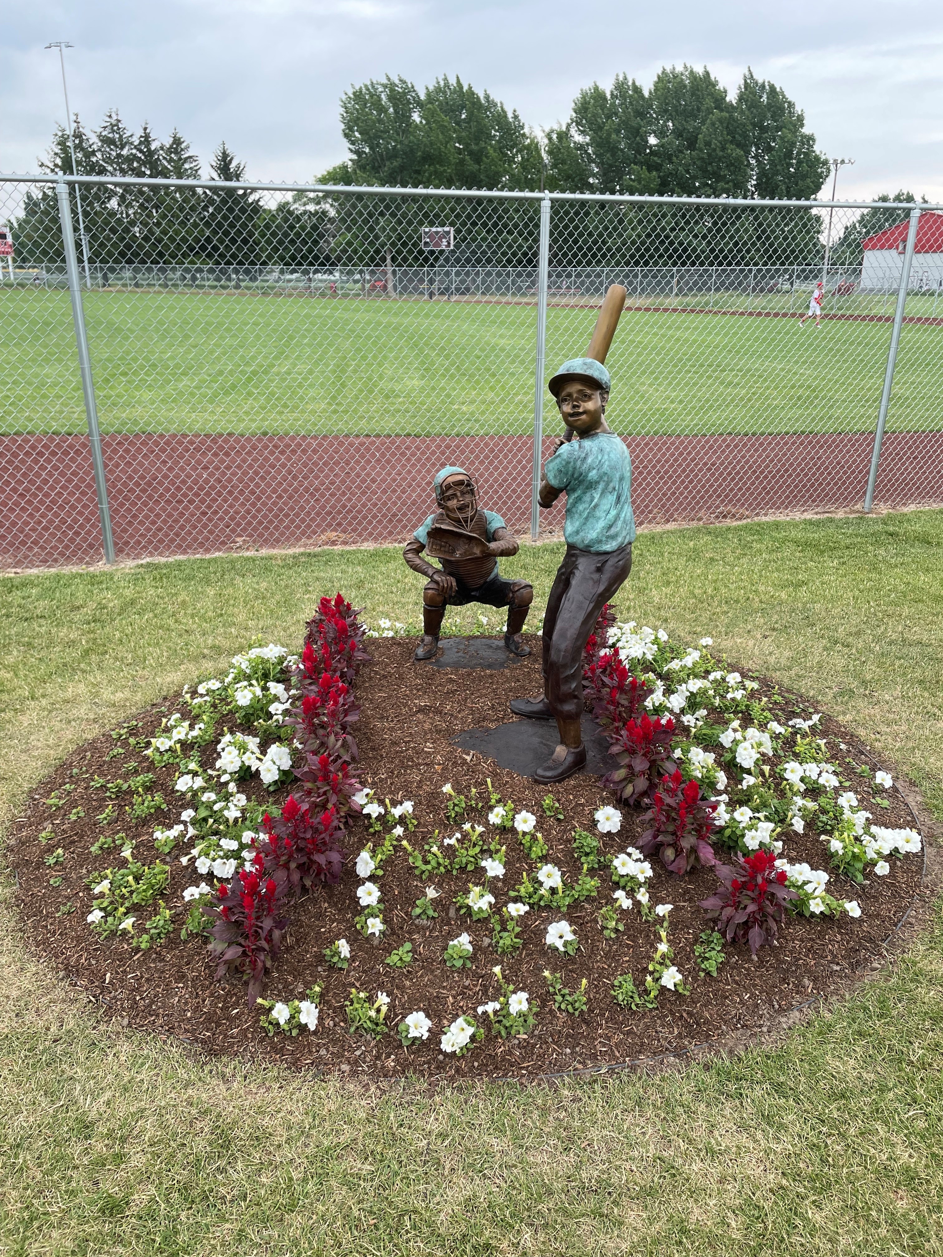 Statue of two boys playing baseball