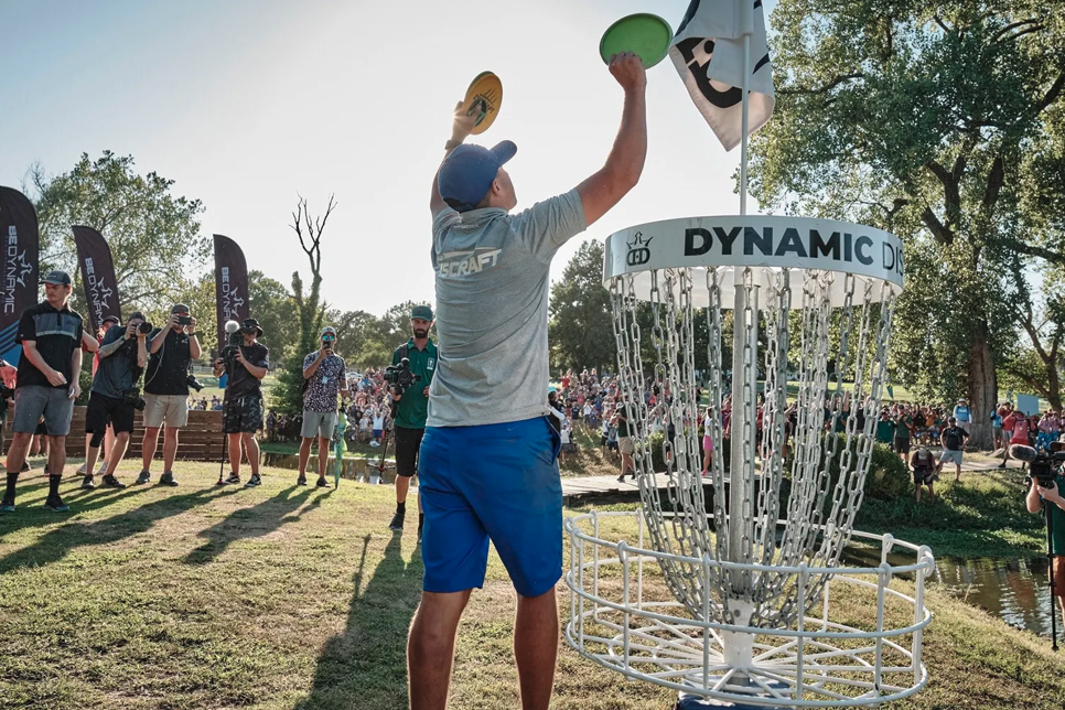 Disc Golfer at disc golf basket