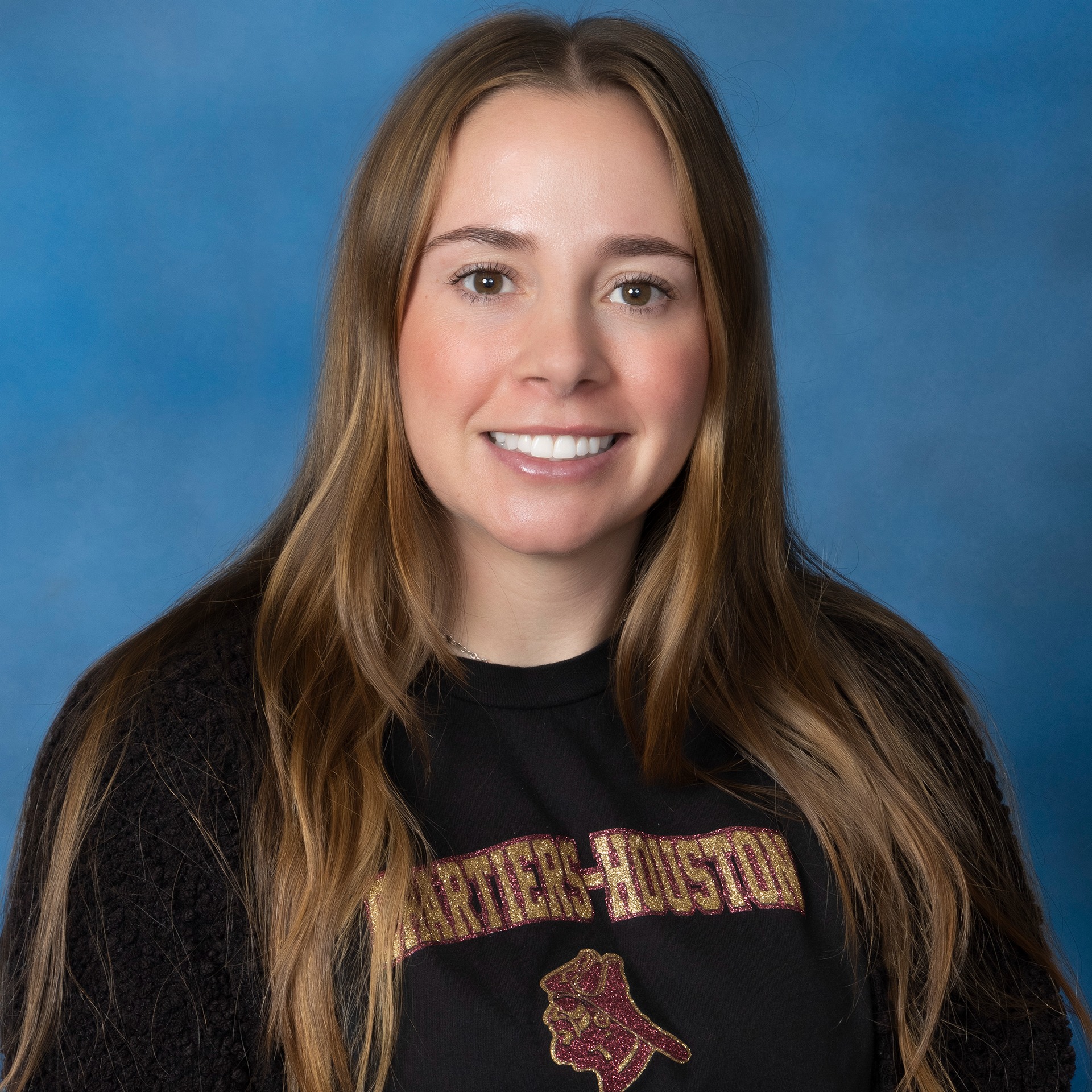 A woman with long hair wearing a black top.