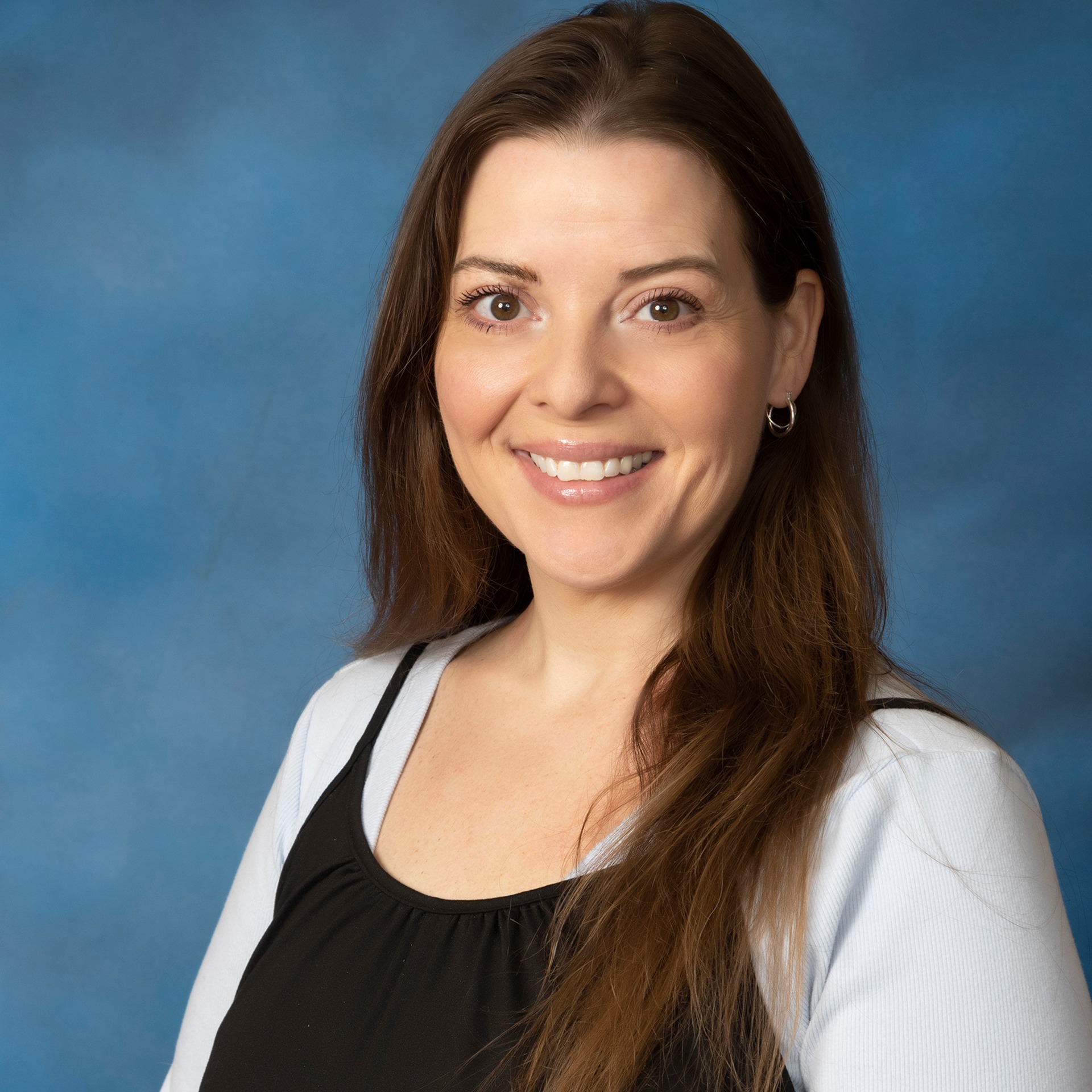  A woman with long hair wearing a white sweater.