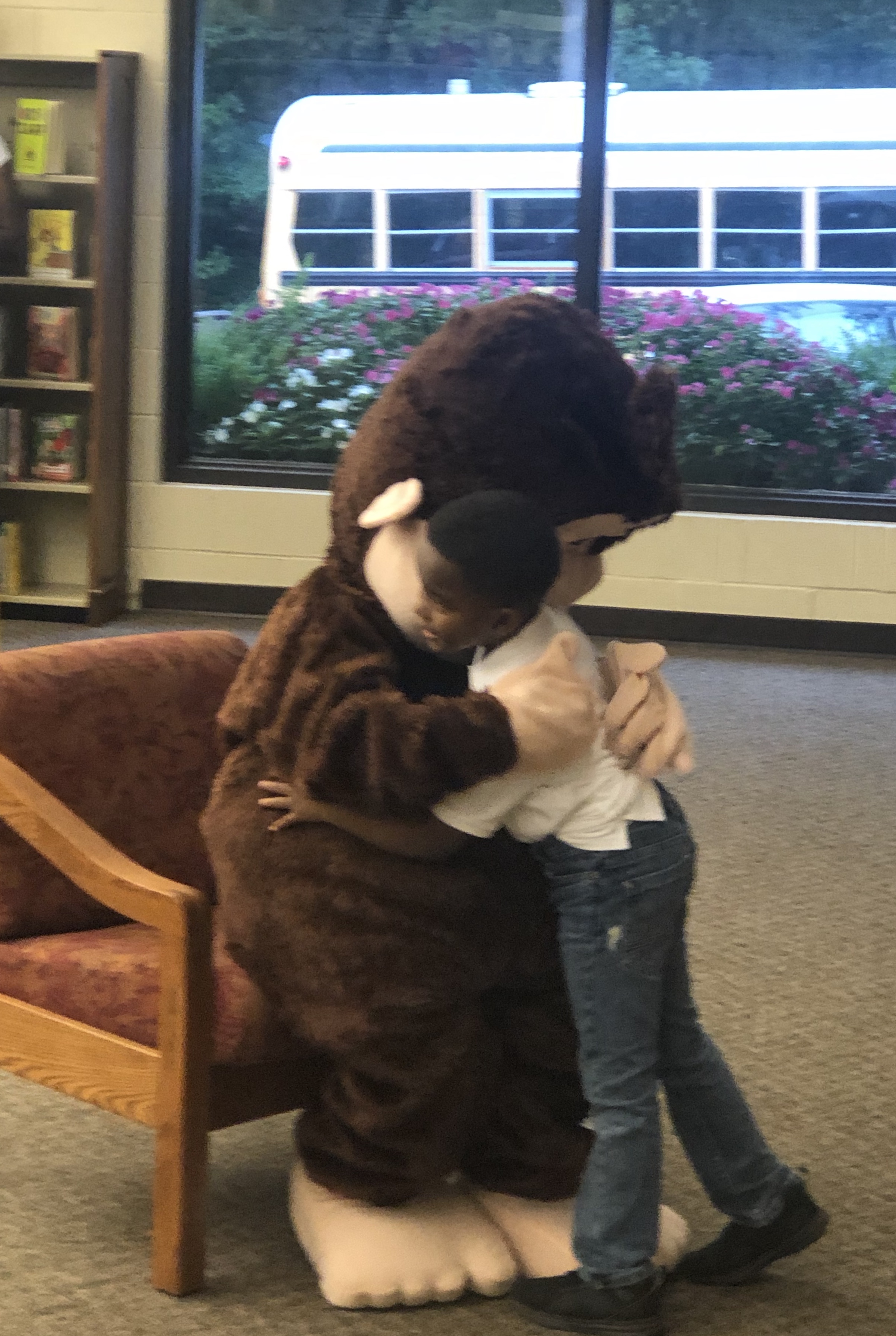 Picture of a child hugging a monkey plush