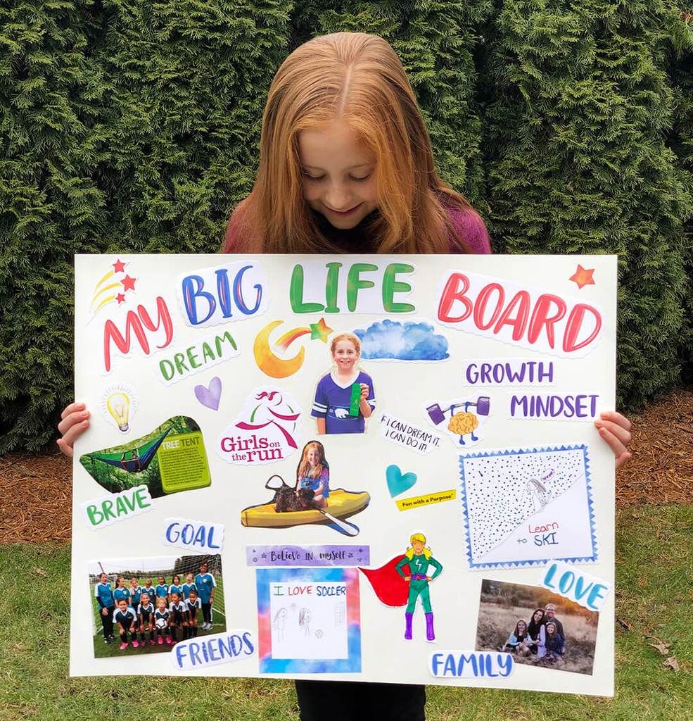 student holding poster board with words