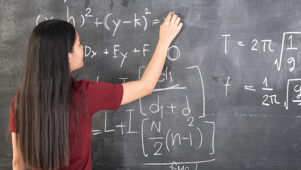 Student working on a chalkboard