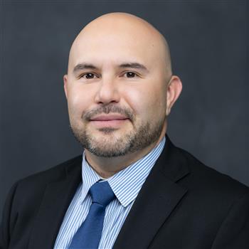 man in a blue shirt and jacket with tie