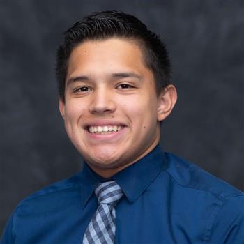 man in a blue shirt with tie