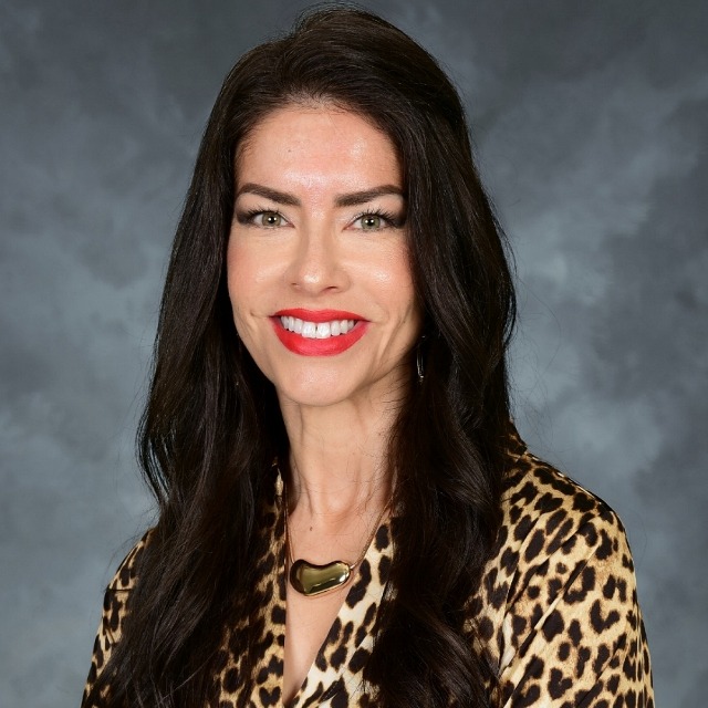Picture of a smiling woman with long brown hair.