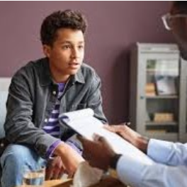 Levels of Care 1 boy sitting at the desk talking to someone