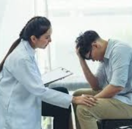 Level of Care 4 Female doctor consoling male patient. Male patient has his hand on his head like he is having a moment.