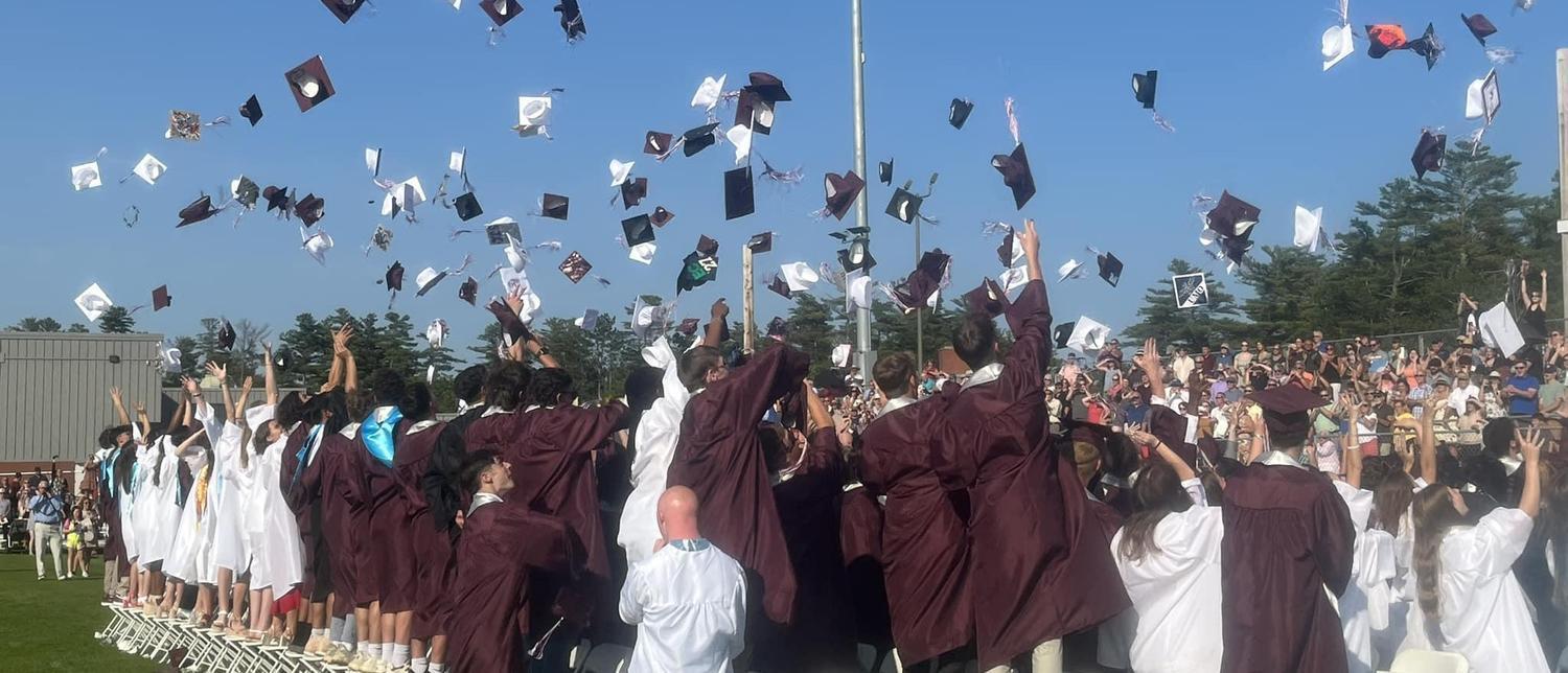 A group of graduates throwing their caps in the air