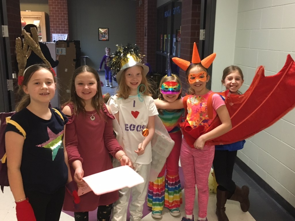 Students in Halloween costumes, posing for a photo.